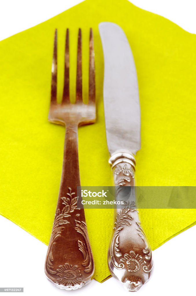 Silverware Old Silver Fork and Table Knife on Green Napkin closeup on white background Arrangement Stock Photo