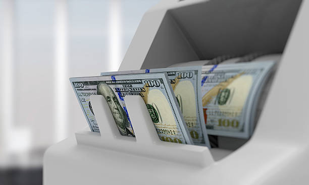 Electronic money counter with dollar bills stock photo