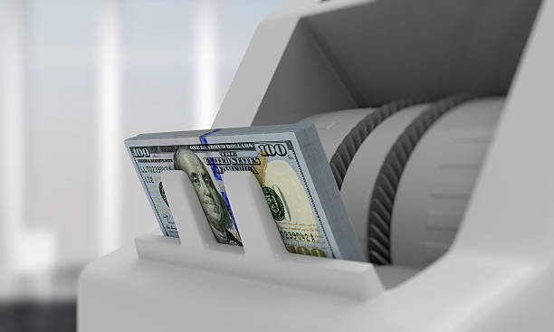 istock Electronic money counter with dollar bills 497143443