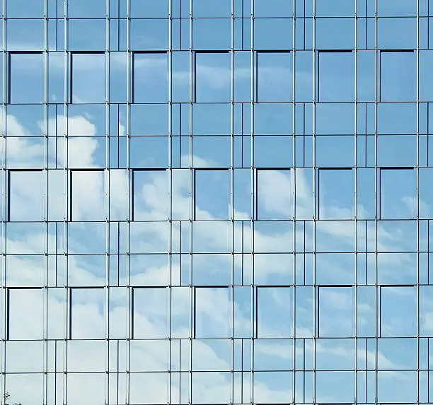 Office building details reflecting, blue sky
