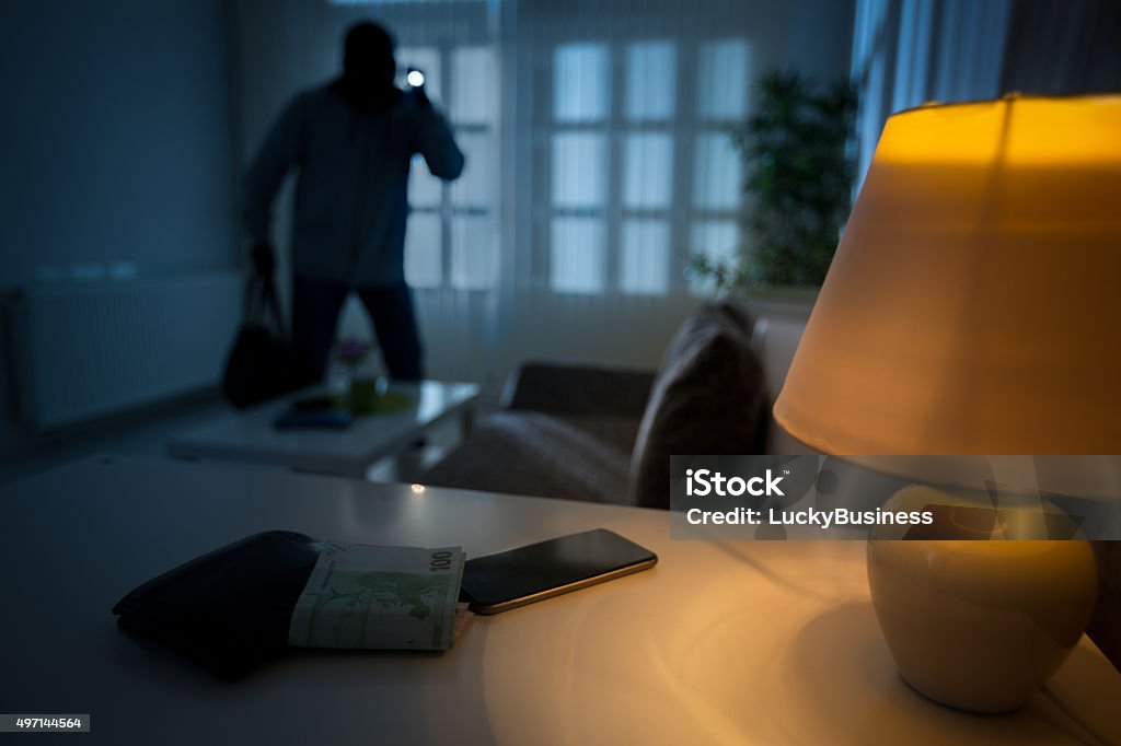 burglar in a house inhabited intrusion of a burglar in a house inhabited Burglary Stock Photo