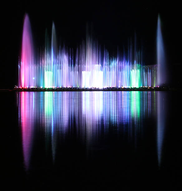 istock Dancing colorful fountain with reflection on water at night. 497144626