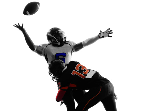 two american football players quarterback sacked fumble in silhouette shadow on white background