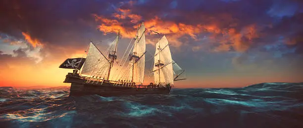 Pirate ship sailing on the open seas at sunset.