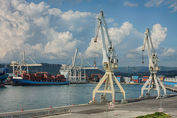 Industrial port of Koper in Slovenia Two cranes in industrial port of Koper in Slovenia in summer cloudy day. koper slovenia stock pictures, royalty-free photos & images
