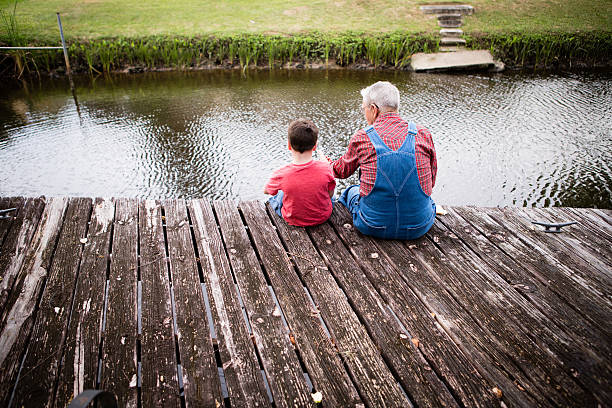 istock Grandpa Fishing With His Great Grandson, Includes Copy Space 497146783