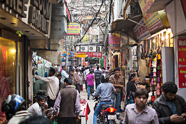 Streets of Old Delhi People in the narrow streets of Old Delhi - India.  india crowd stock pictures, royalty-free photos & images