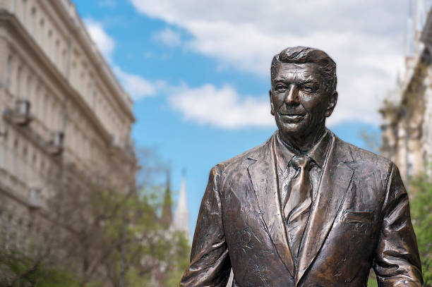 Budapest, Hungary - April 19, 2015: Statue of the former U.S. President Ronald Reagan on the background of Hungarian Parliament Building. Statue by sculptor Istvan Mate was unveiled on June 29, 2011.