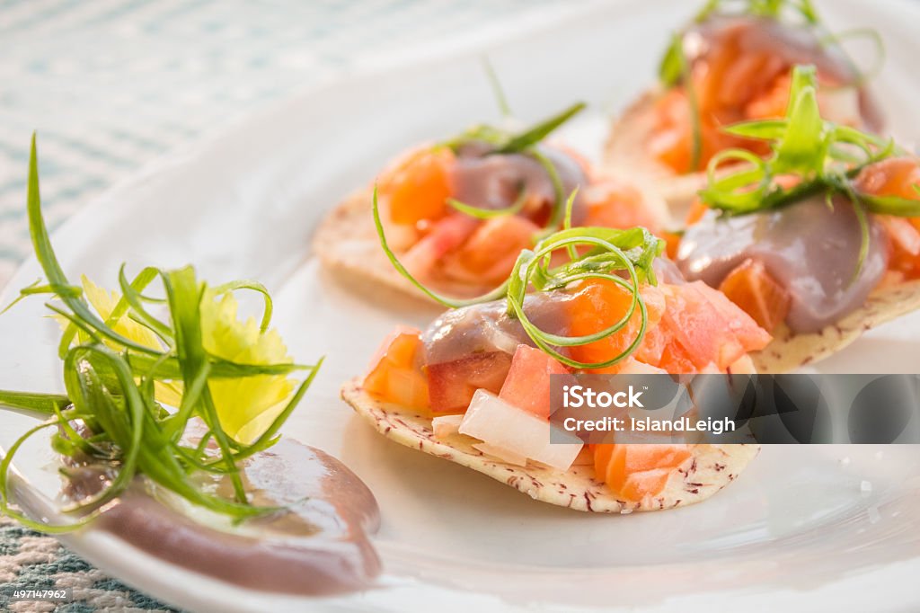 Salmon Ceviche Salmon ceviche served on taro chips topped with poi and green onion garnish Salmon - Seafood Stock Photo