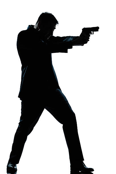 istock silhouette man full length shooting with gun 497148691