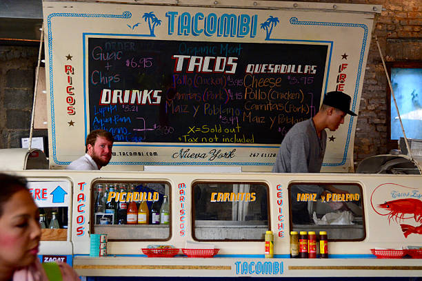 Tacombi Food truck at gansevoort food market Manhattan New York, USA - November 15, 2015: Gansevoort food market Manhattan New York City with people enjoying drinks and food that is being sold 21st century style stock pictures, royalty-free photos & images