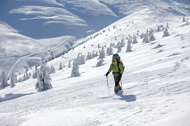 istock Backpacker woman is walking in winter mountains on sunny day 497150402