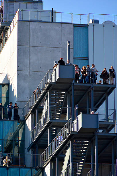 Whitney museum, High Line Manhattan on a sunny day New York, USA - November 15, 2015: View of the new Whitney museum taken from the street in Manhattan on a sunny day withe people on roof terrace in the Meatpacking District. The new museum, a six-story, asymmetrical building designed by Renzo Piano, will house more of the museums 18,000-piece permanent collection. 21st century style stock pictures, royalty-free photos & images