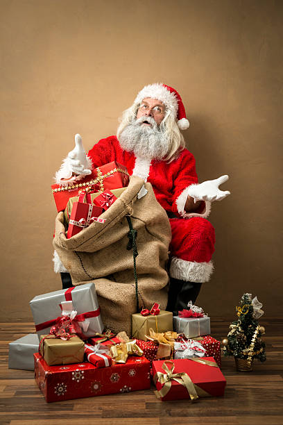 istock tired looking santa claus with many gifts 497152188