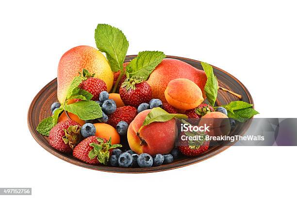 Fruits And Berries Mix In Ceramic Plate Isolated On White Stockfoto en meer beelden van 2015