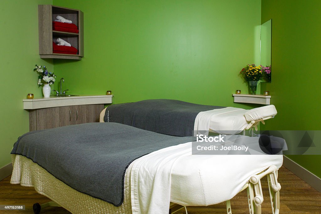 Massage and Spa Room Two massage tables in a green spa room. Bed - Furniture Stock Photo