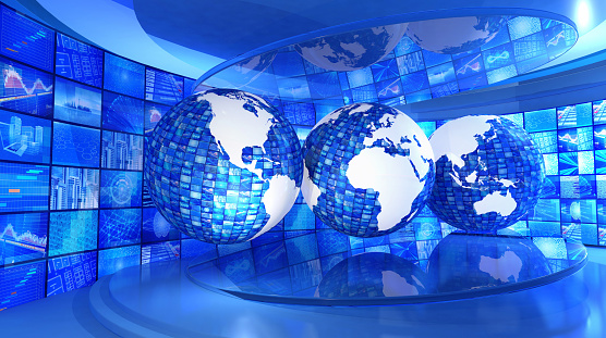 Television broadcasting studio with three Earth globes showing full world map surrounded by a video wall of business and technology images. Behind the globes a stream of video images shows multiple screens with concepts related to science, technology and economy. Global news and economy with multimedia technology. Blue background. Widescreen effect, 16/9 format. Digitally generated image, copy space.