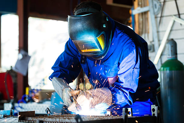 istock Welder welding metal in workshop with sparks 497154236