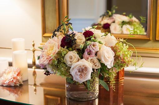 Beautiful bouquet with peonies, roses, and hydrangeas with reflection in morror.