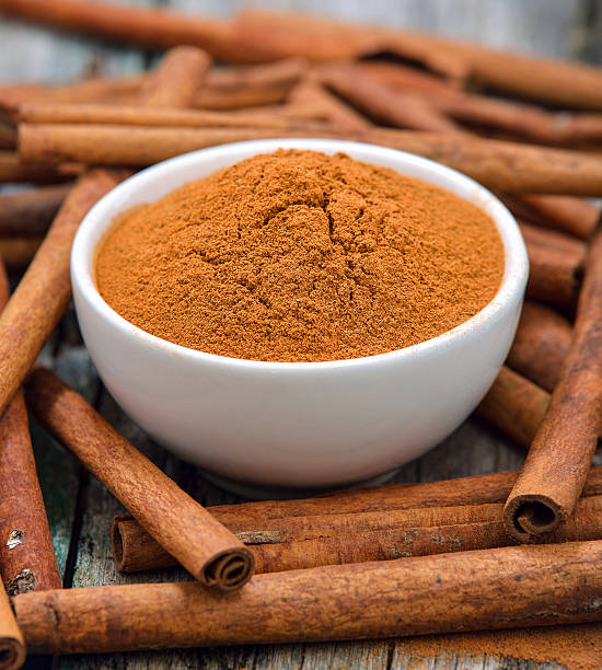 istock Cinnamon sticks and powder cinnamon in the bowl on table 497154946