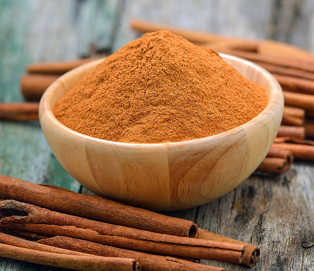 istock Cinnamon sticks and powder cinnamon in the bowl on table 497154994