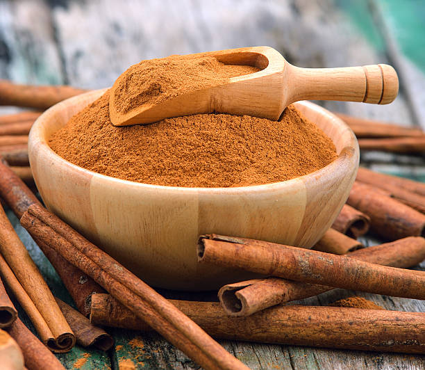 istock Cinnamon sticks and powder cinnamon in the bowl on table 497155028