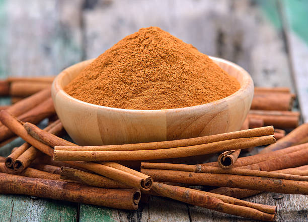 istock Cinnamon sticks and powder cinnamon in the bowl on table 497155132