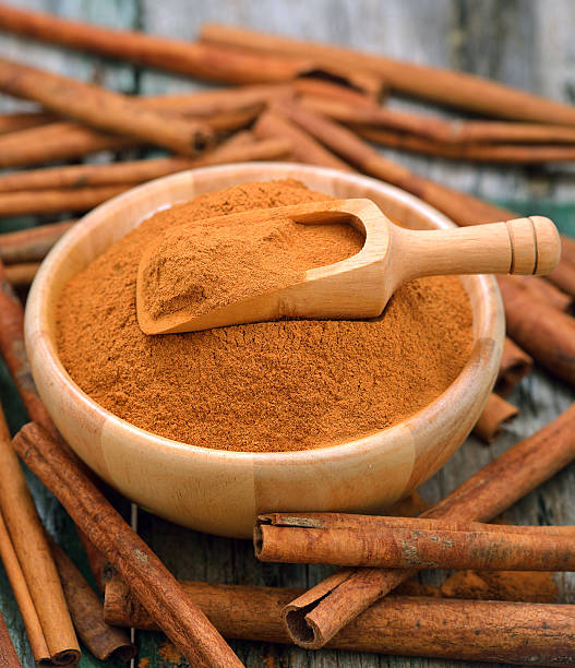 istock Cinnamon sticks and powder cinnamon in the bowl on table 497155242