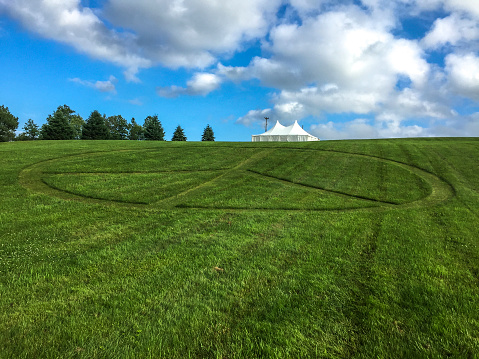 Peace sign mowed into the rolling green lawn at Bethel, New York and the site of the original Woodstock Music Festival.
