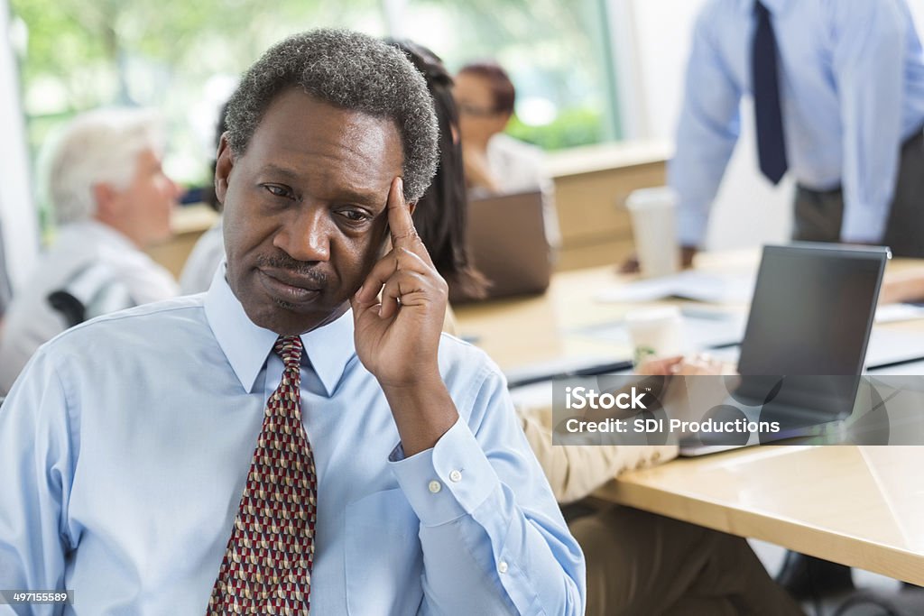 Concerned African American businessman worried during business meeting Distracted Stock Photo