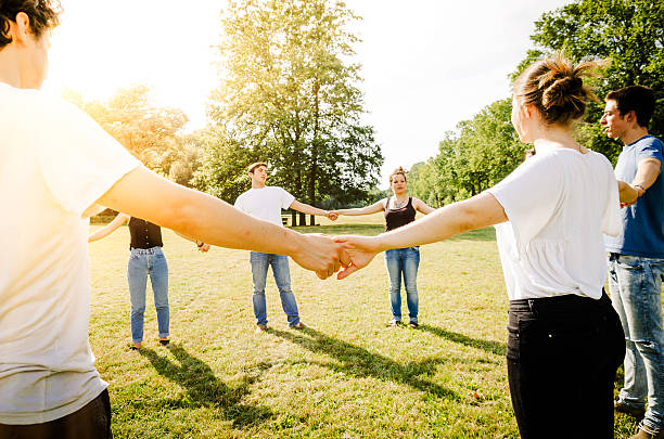 istock Friends holding hands in the park 497155669