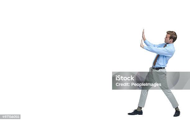 Holding Back The Recession Stock Photo - Download Image Now - Pushing, Men, Leaning