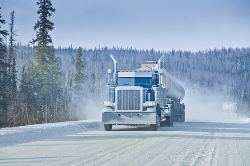 Big Rig Semi-Truck driving on an Arctic Winter Highway in Alaska