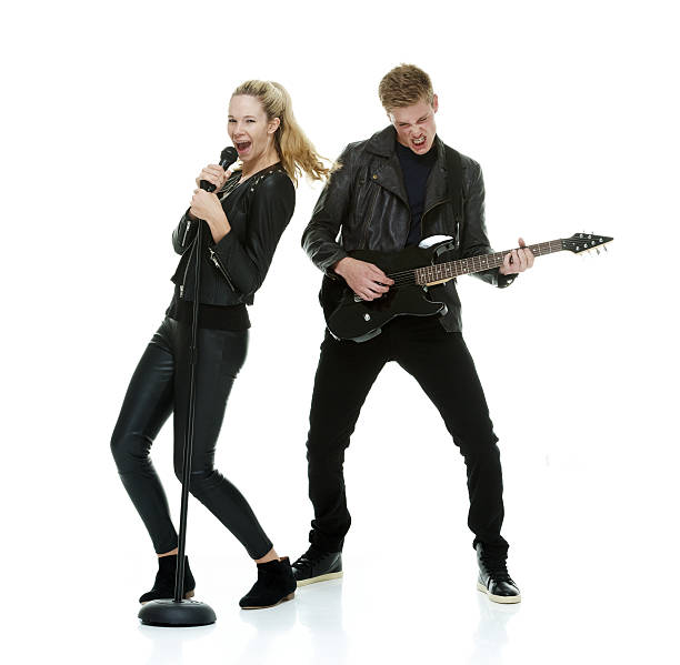 Two cheerful people playing guitar Two cheerful people playing guitarhttp://www.twodozendesign.info/i/1.png rock group photos stock pictures, royalty-free photos & images