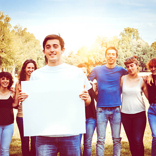istock Goup of friends holding a billboard for copy space 497156945
