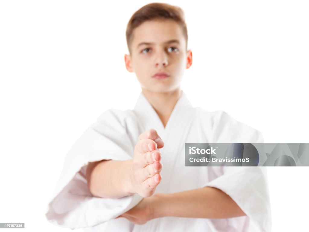 Martial art sport karate - boy in white kimono training Martial art sport karate - child teen boy in white kimono training karate punch and block 2015 Stock Photo