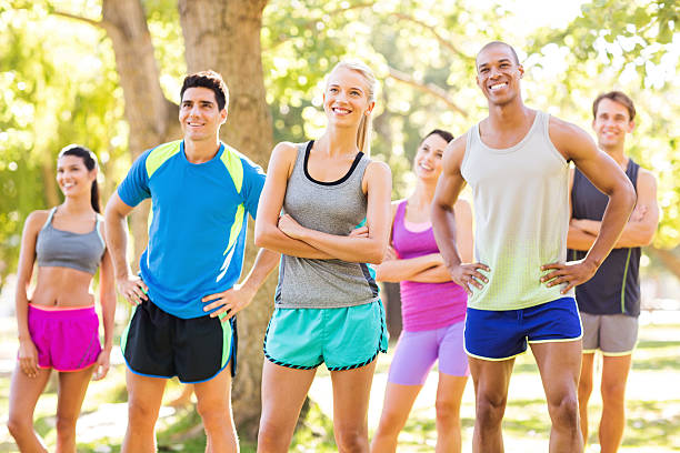 istock Smiling Fit Friends Looking Away In Park 497158275