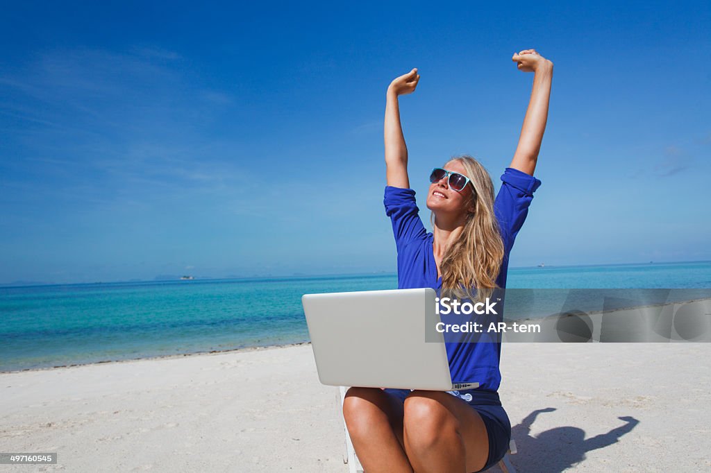 Free-lancer dream Beautiful young woman working with laptop on the tropical beach Beach Stock Photo