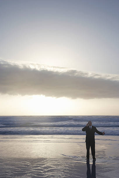 istock Businessman Using Cell Phone In Sea 497161453
