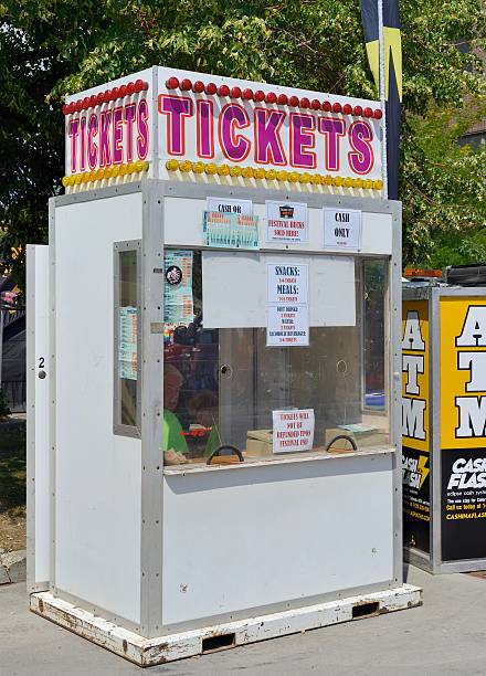 Fort Collins, Colorado, USA - August 18, 2013: People inside a ticket  booth at the New West Fest in Fort Collins. New West Fest is an annual street festival with arts, crafts, food, amusement rides, and concerts. 2013 marked its 25th anniversary.