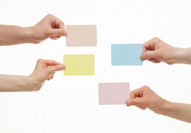 istock Human hands holding colorful paper cards 497180394