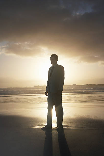 istock Young Businessman Standing On Beach 497180453