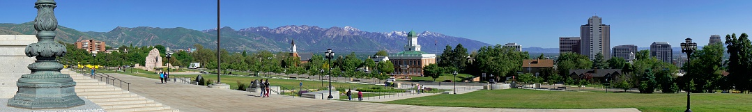 Salt Lake City, Utah, USA - June 1, 2014: People in a park at the steps of the capitol with skyline of Salt Lake City in the background.