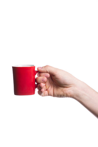 istock Hand holding a red cup isolated on white background 497180987