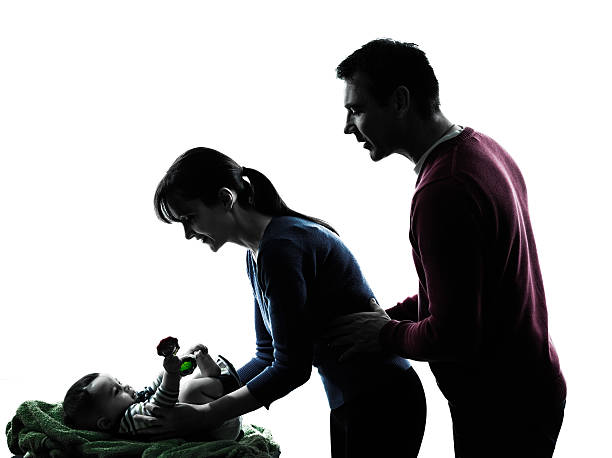 istock parents with baby silhouette 497181983