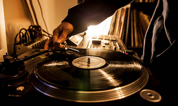 Dj in studio with turntable Dj in studio puts needle on record. sewing needle photos stock pictures, royalty-free photos & images