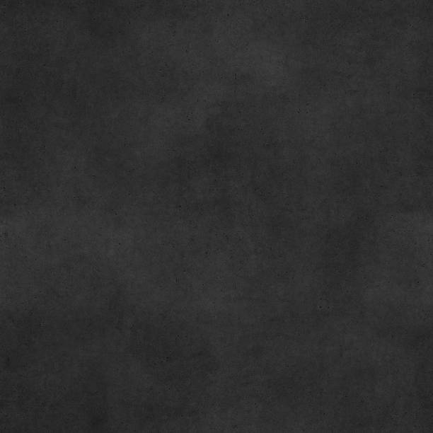 istock Seamless raw uneven polluted dotted black concrete stone block texture 497184982