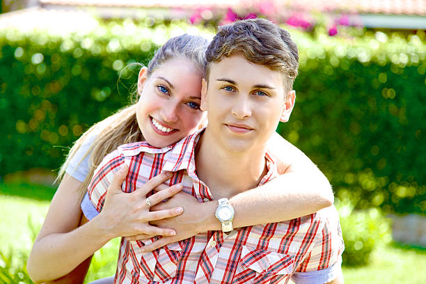istock Happy handsome young man hugged by cute girlfriend 497185175