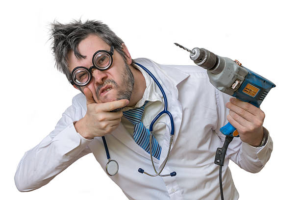 istock Freaky unsure mad dentist doctor with drill in hand isolated 497186390