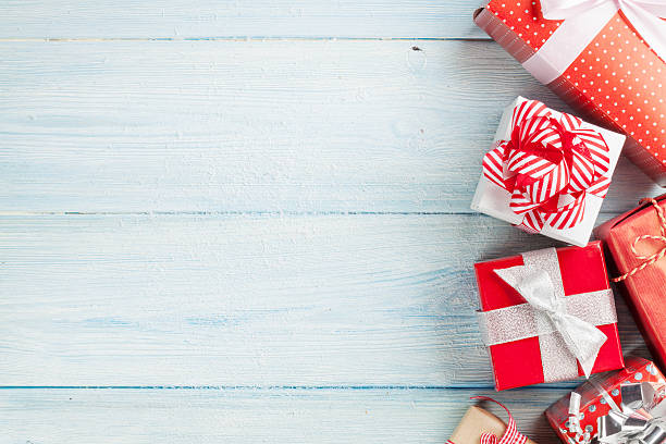istock Christmas gift boxes on wooden table 497186616